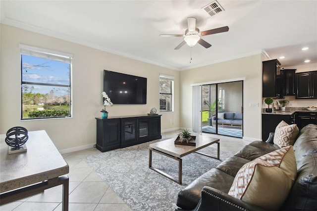 living room with crown molding, ceiling fan, and light tile patterned flooring