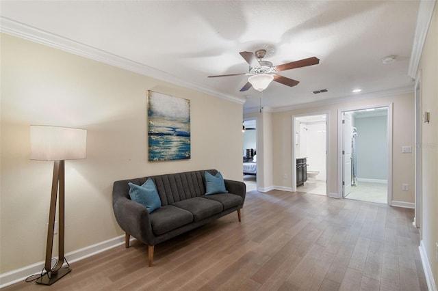 sitting room featuring hardwood / wood-style floors, crown molding, and ceiling fan