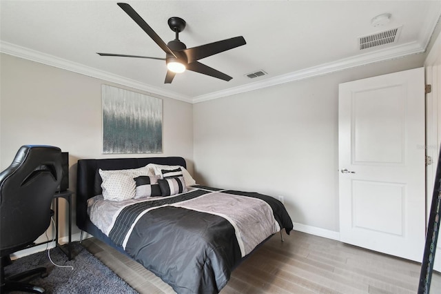 bedroom featuring hardwood / wood-style flooring, ornamental molding, and ceiling fan