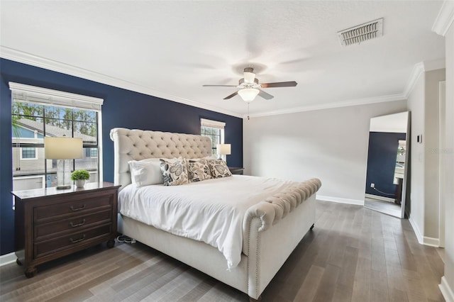 bedroom featuring crown molding, dark hardwood / wood-style floors, and ceiling fan