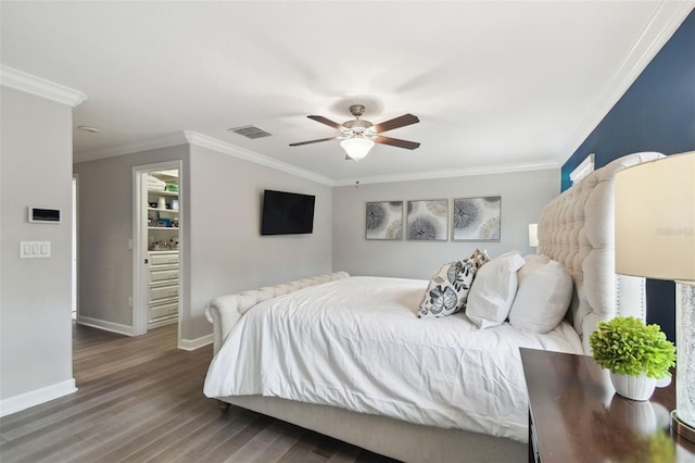 bedroom featuring ceiling fan, ornamental molding, and dark hardwood / wood-style floors