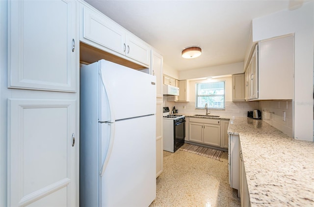 kitchen featuring sink, white appliances, backsplash, light stone counters, and white cabinets