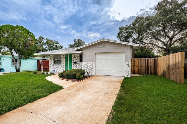 single story home with a garage and a front lawn