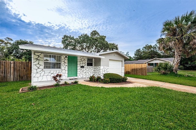 ranch-style house with a garage and a front yard