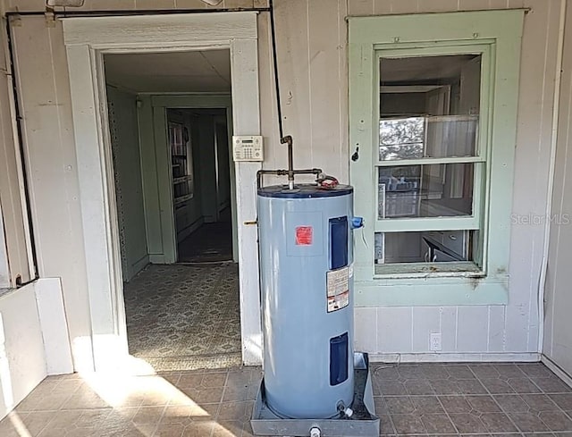 utility room featuring water heater