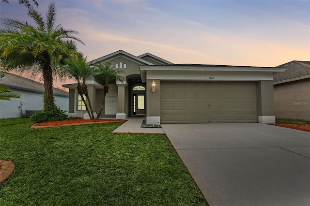 view of front facade with a garage and a yard