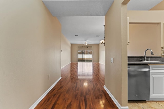 hall featuring sink and light hardwood / wood-style floors