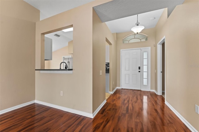 foyer with dark hardwood / wood-style floors