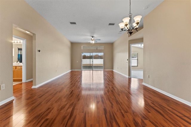 unfurnished living room featuring dark hardwood / wood-style floors and ceiling fan with notable chandelier