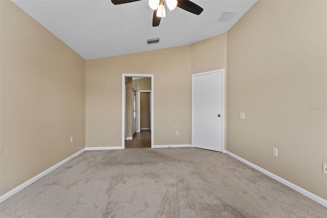 unfurnished room with lofted ceiling, carpet floors, and ceiling fan