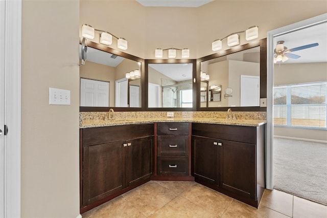 bathroom featuring ceiling fan, lofted ceiling, vanity, and tile patterned flooring