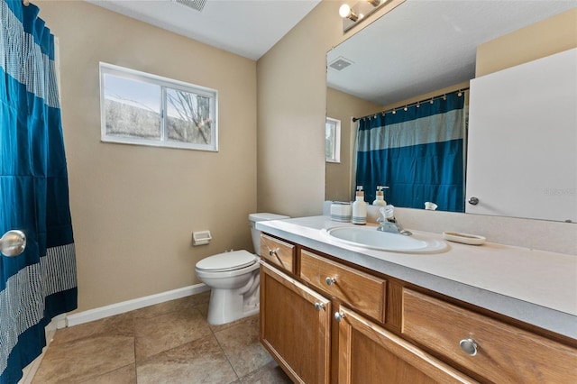 bathroom featuring vanity, tile patterned floors, and toilet