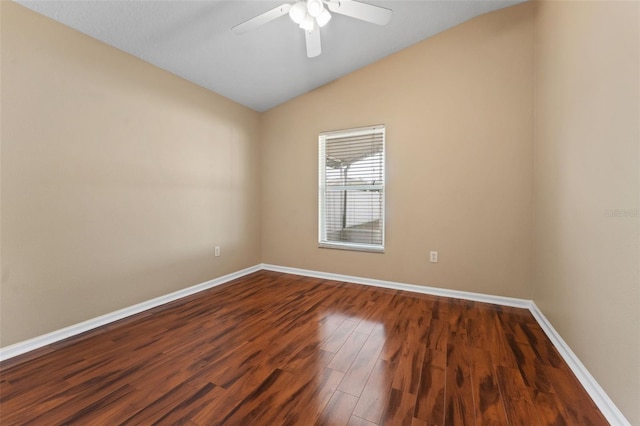 spare room featuring ceiling fan, dark hardwood / wood-style floors, and vaulted ceiling