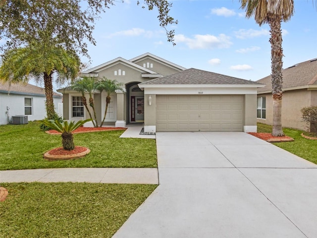 5809 War Admiral Dr, Wesley Chapel, FL 33544 - ranch-style home featuring a garage, driveway, stucco siding, a front yard, and roof with shingles