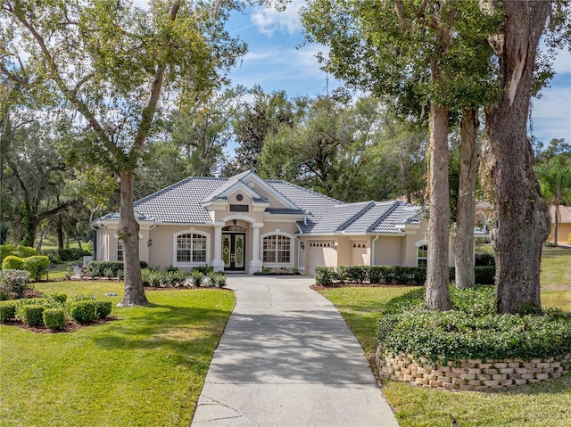 view of front of home featuring a garage and a front lawn