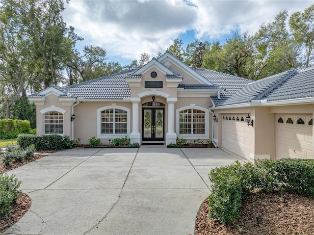 view of front of house with french doors and a garage