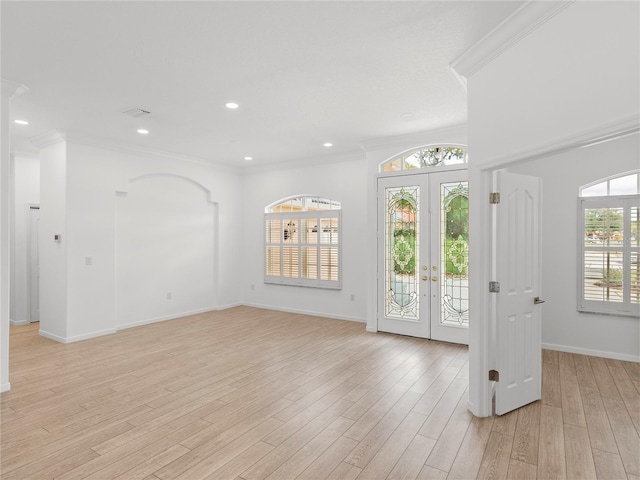 entryway with french doors, ornamental molding, and light hardwood / wood-style floors