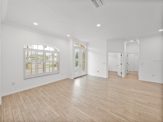 unfurnished room with french doors, crown molding, and light hardwood / wood-style flooring