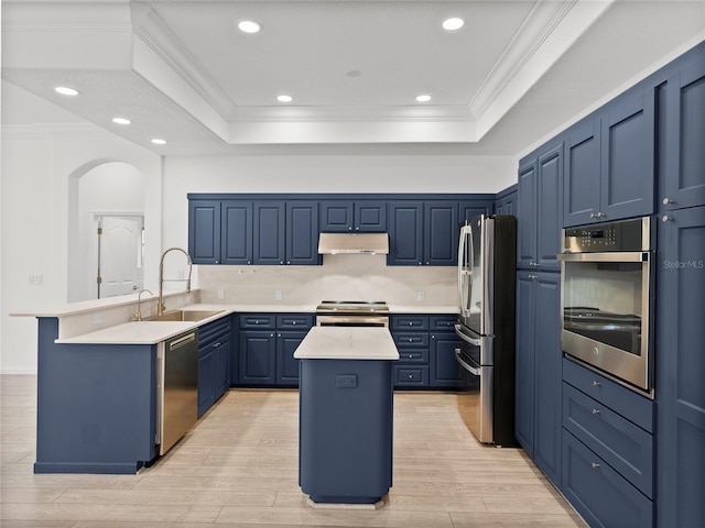 kitchen featuring stainless steel appliances, a center island, sink, and blue cabinetry