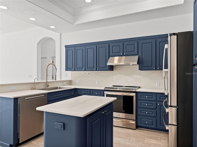 kitchen featuring blue cabinets, light hardwood / wood-style flooring, a center island, and appliances with stainless steel finishes