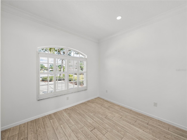 empty room featuring ornamental molding and light hardwood / wood-style flooring