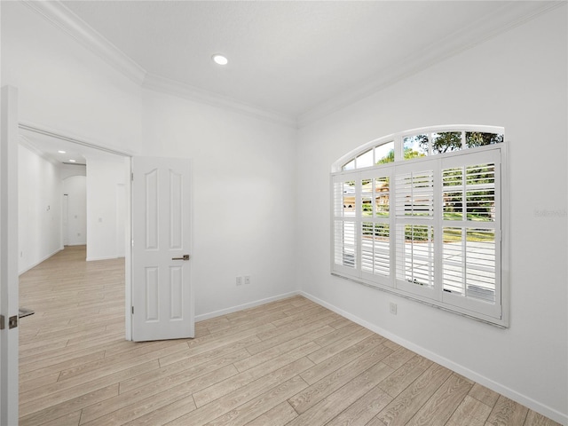 unfurnished room featuring crown molding and light hardwood / wood-style floors