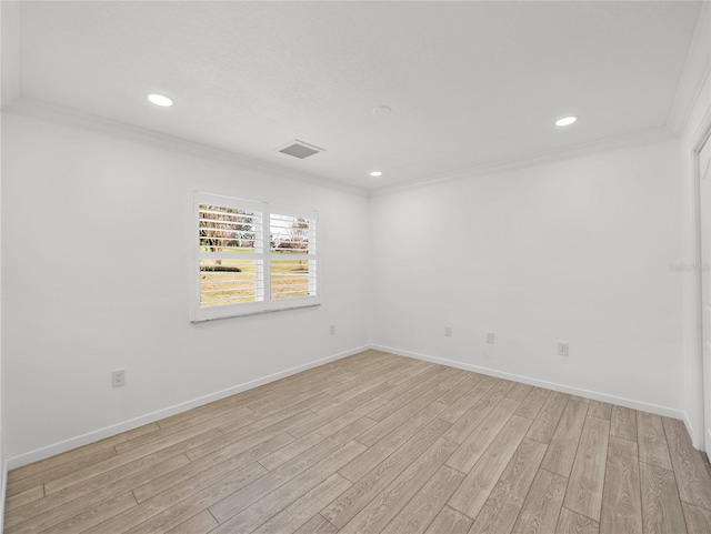 unfurnished room with ornamental molding and light wood-type flooring