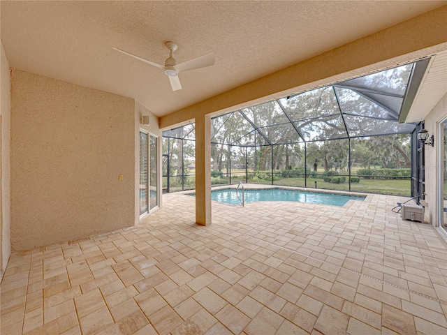 view of pool with a patio and glass enclosure