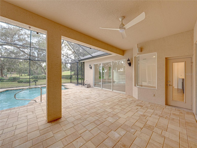 view of swimming pool featuring a lanai and a patio