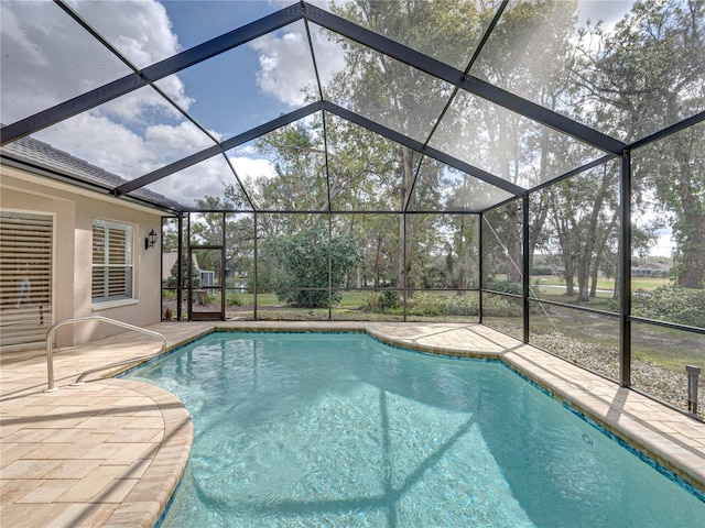 view of swimming pool with a lanai and a patio area