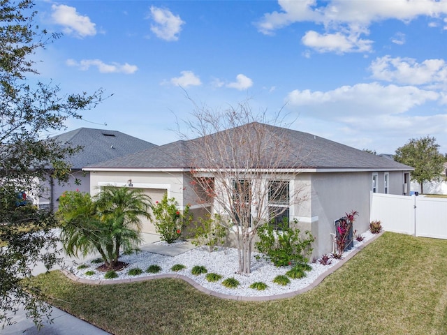 ranch-style house featuring a garage and a front lawn