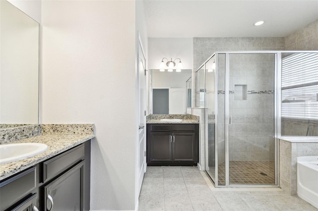 bathroom featuring vanity, tile patterned floors, and shower with separate bathtub