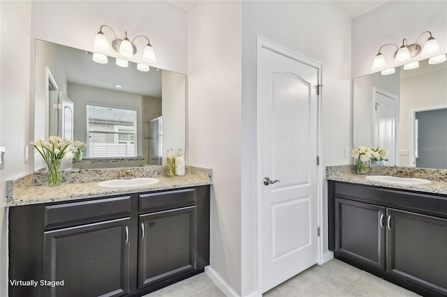 bathroom featuring tile patterned floors, vanity, and a shower with shower door