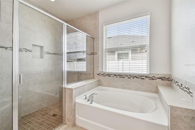 bathroom featuring separate shower and tub