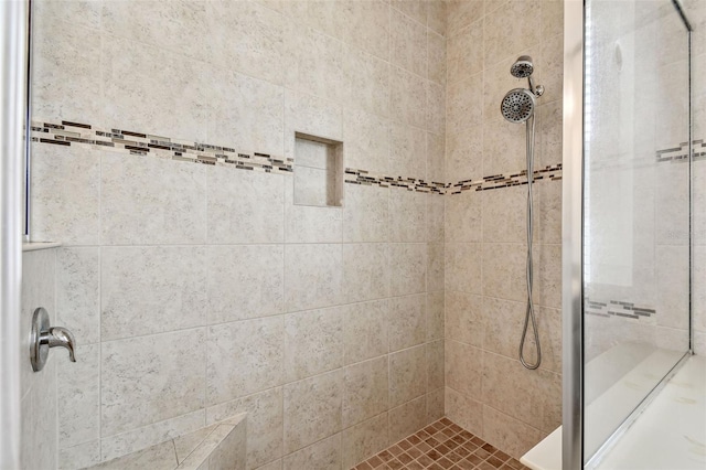 bathroom with a tile shower