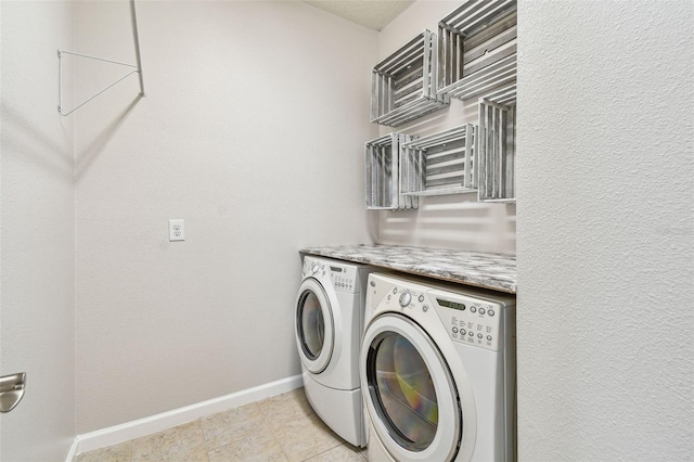 laundry room with washer and clothes dryer and light tile patterned flooring