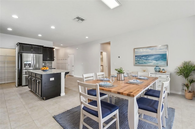 dining space featuring light tile patterned floors