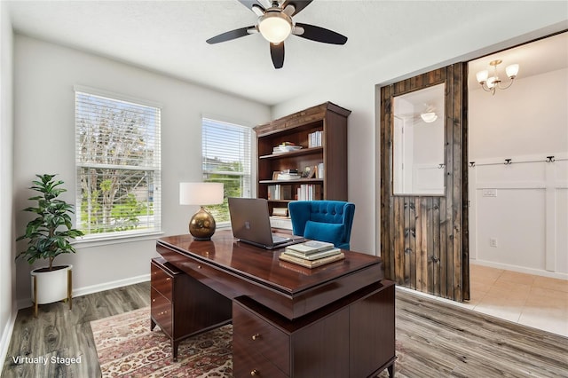 office area featuring wood-type flooring and ceiling fan with notable chandelier