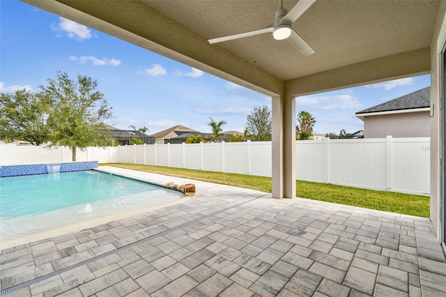 view of pool featuring pool water feature, ceiling fan, and a patio area