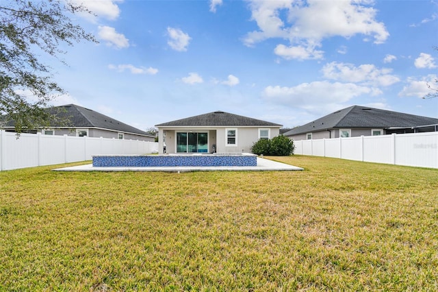 rear view of house featuring a patio and a lawn