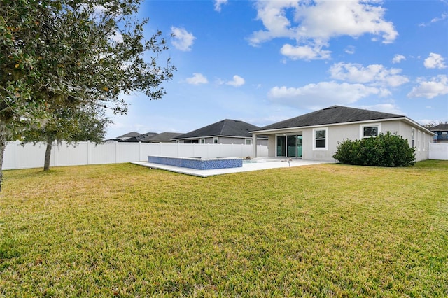 back of property featuring a yard and a patio area