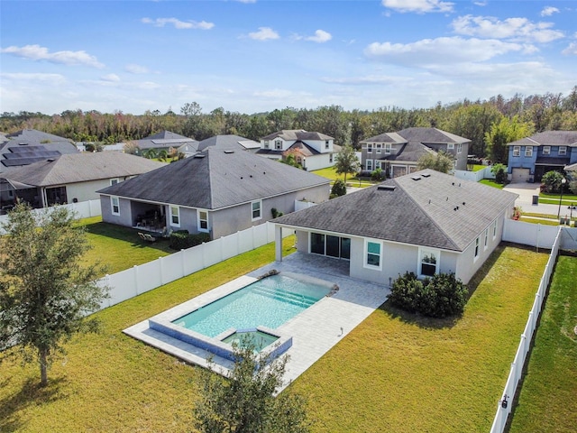 view of pool with an in ground hot tub, a yard, and a patio area