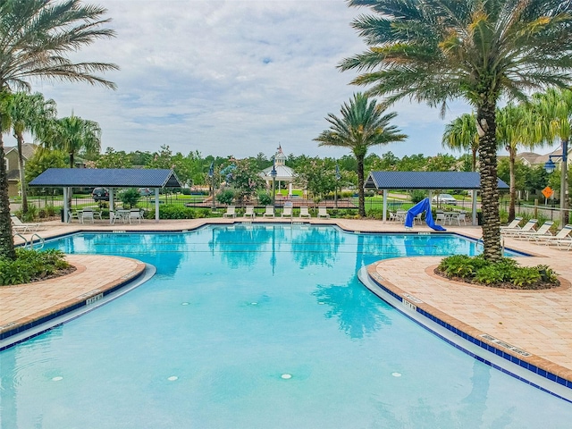 view of pool featuring a gazebo, a patio, and a water slide