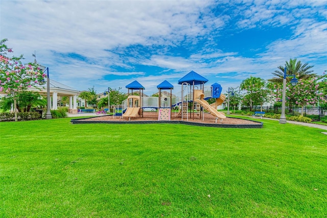 view of playground with a lawn