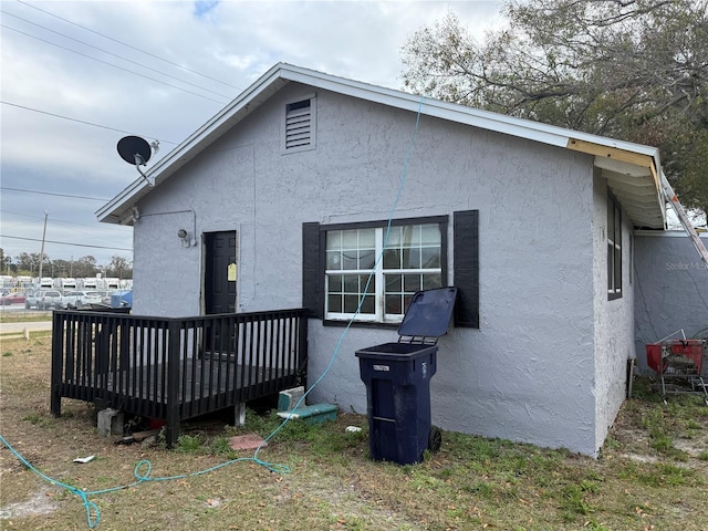 back of house with a wooden deck