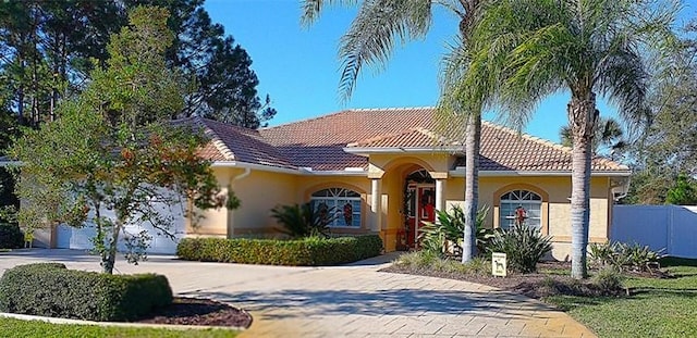 mediterranean / spanish house featuring a garage