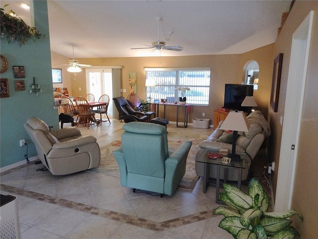 tiled living room with lofted ceiling and ceiling fan