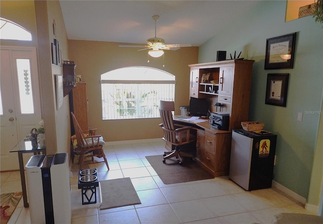 office space featuring ceiling fan, vaulted ceiling, and light tile patterned floors