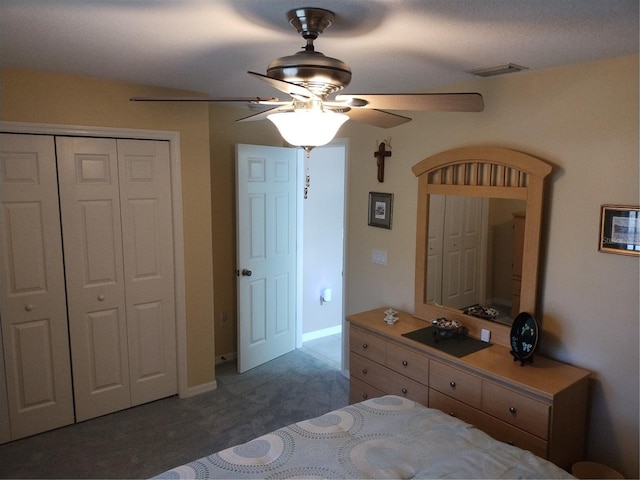 carpeted bedroom featuring a closet and ceiling fan