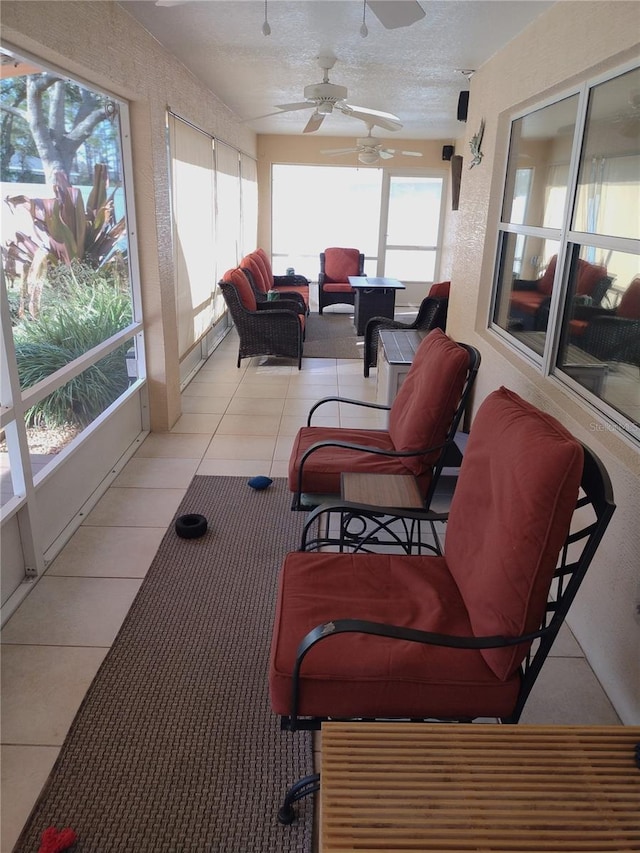 sunroom featuring a healthy amount of sunlight and ceiling fan